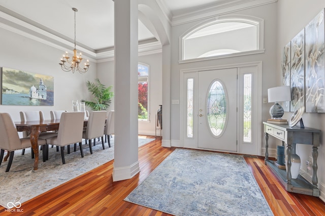 4396 W Eagle Trce, New Palestine, IN 46163 - foyer with ornamental molding, wood-type flooring, a chandelier, and arched walkways