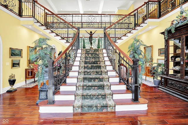 11557 Willow Springs Dr, Zionsville, IN 46077 - staircase featuring wood finished floors, arched walkways, ornamental molding, and a high ceiling