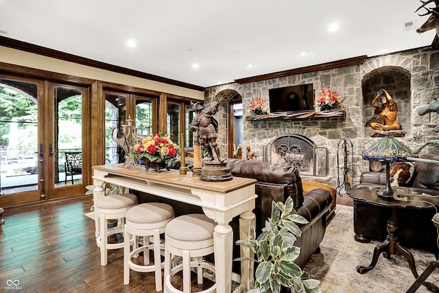 11557 Willow Springs Dr, Zionsville, IN 46077 - living area featuring french doors, ornamental molding, hardwood / wood-style floors, a stone fireplace, and recessed lighting