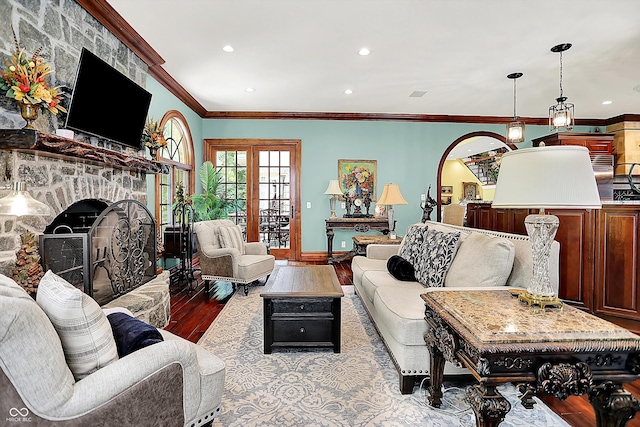 11557 Willow Springs Dr, Zionsville, IN 46077 - living room with a stone fireplace, wood finished floors, recessed lighting, and ornamental molding