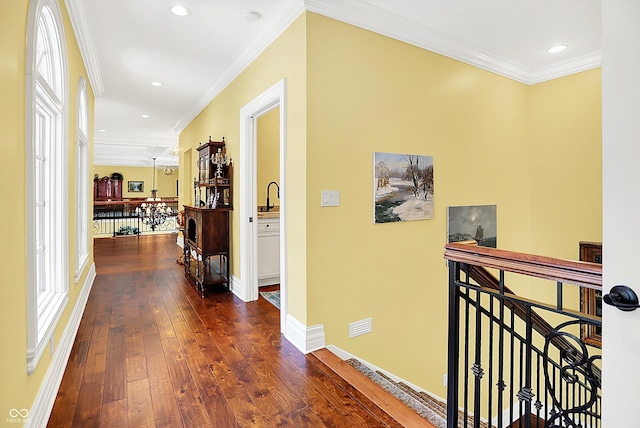 11557 Willow Springs Dr, Zionsville, IN 46077 - hall featuring an upstairs landing, dark wood-type flooring, ornamental molding, and recessed lighting