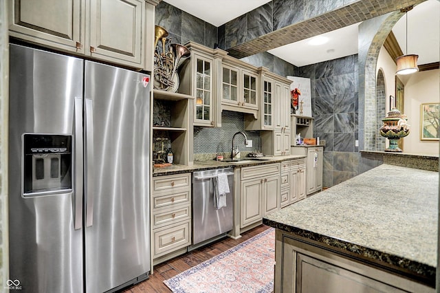 11557 Willow Springs Dr, Zionsville, IN 46077 - kitchen featuring stainless steel appliances, open shelves, wood finished floors, decorative backsplash, and glass insert cabinets