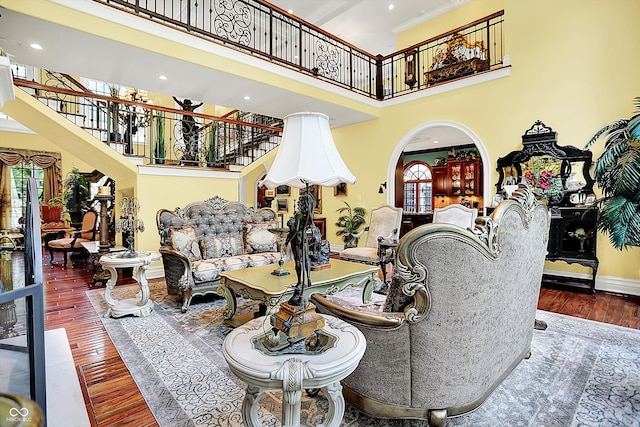 11557 Willow Springs Dr, Zionsville, IN 46077 - living area with a towering ceiling, hardwood / wood-style floors, stairs, recessed lighting, and arched walkways