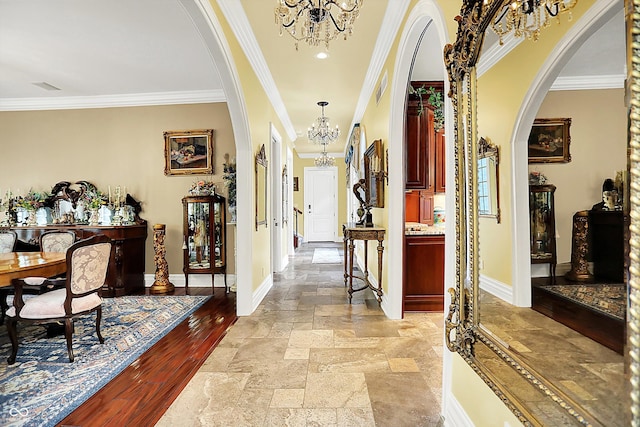 11557 Willow Springs Dr, Zionsville, IN 46077 - corridor featuring arched walkways, a chandelier, crown molding, and stone tile floors