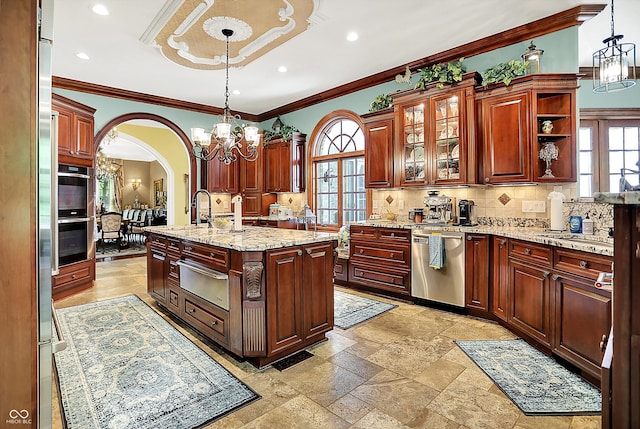 11557 Willow Springs Dr, Zionsville, IN 46077 - kitchen with a chandelier, appliances with stainless steel finishes, a warming drawer, plenty of natural light, and crown molding