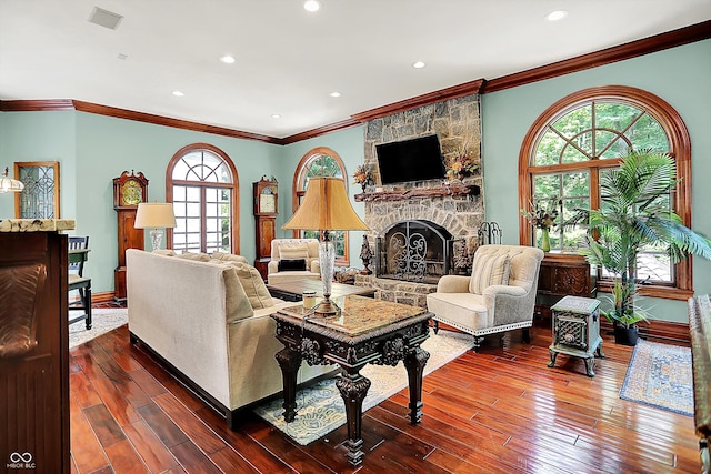 11557 Willow Springs Dr, Zionsville, IN 46077 - living area featuring hardwood / wood-style floors, plenty of natural light, a stone fireplace, crown molding, and recessed lighting