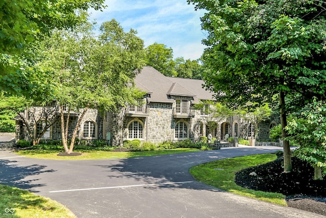 11557 Willow Springs Dr, Zionsville, IN 46077 - french country home with stone siding and a balcony