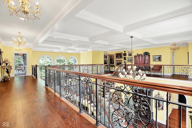 11557 Willow Springs Dr, Zionsville, IN 46077 - hall featuring a chandelier, an upstairs landing, beamed ceiling, coffered ceiling, and ornamental molding