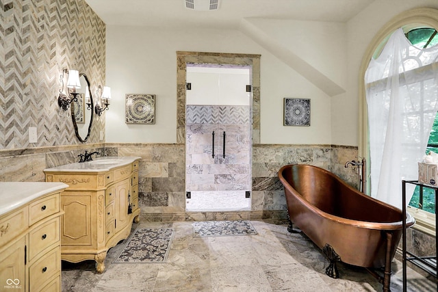 11557 Willow Springs Dr, Zionsville, IN 46077 - full bath featuring tile walls, a wainscoted wall, a shower stall, vanity, and a freestanding bath