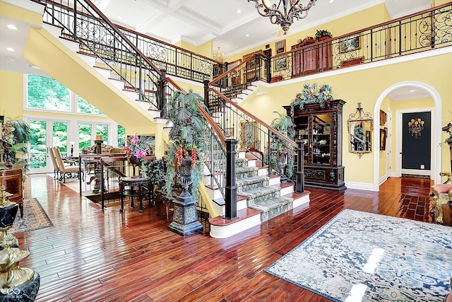 11557 Willow Springs Dr, Zionsville, IN 46077 - stairs with a towering ceiling, wood-type flooring, arched walkways, ornamental molding, and recessed lighting