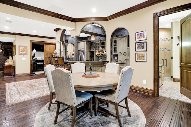 11557 Willow Springs Dr, Zionsville, IN 46077 - dining space with dark wood-style floors, crown molding, recessed lighting, and arched walkways