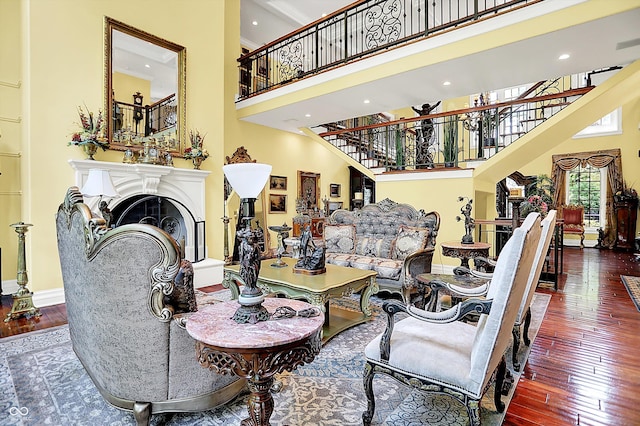 11557 Willow Springs Dr, Zionsville, IN 46077 - living room with a towering ceiling, stairs, wood-type flooring, recessed lighting, and a fireplace