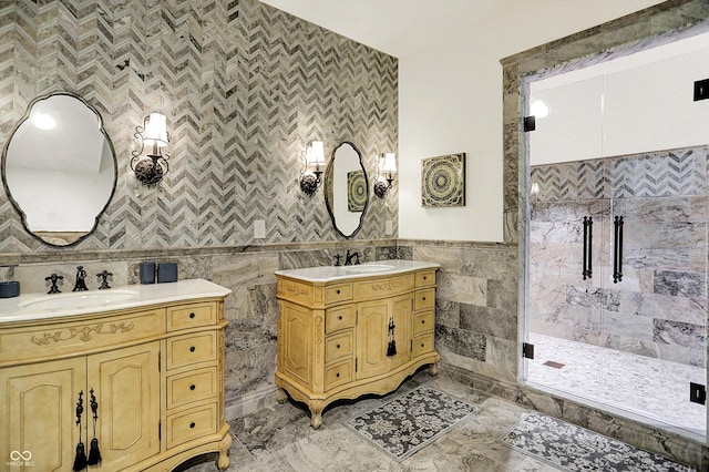 11557 Willow Springs Dr, Zionsville, IN 46077 - bathroom featuring tile walls, two vanities, a stall shower, a wainscoted wall, and marble finish floors