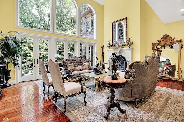 11557 Willow Springs Dr, Zionsville, IN 46077 - living room featuring a high ceiling, hardwood / wood-style flooring, and a glass covered fireplace