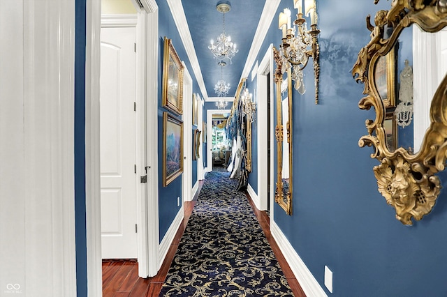11557 Willow Springs Dr, Zionsville, IN 46077 - hallway with a chandelier, crown molding, and dark carpet