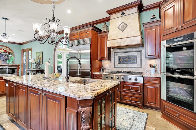 11557 Willow Springs Dr, Zionsville, IN 46077 - kitchen with built in appliances, crown molding, premium range hood, a kitchen island with sink, and tasteful backsplash