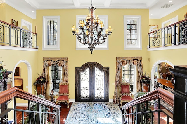 11557 Willow Springs Dr, Zionsville, IN 46077 - entrance foyer with a chandelier, french doors, wood finished floors, recessed lighting, and a high ceiling