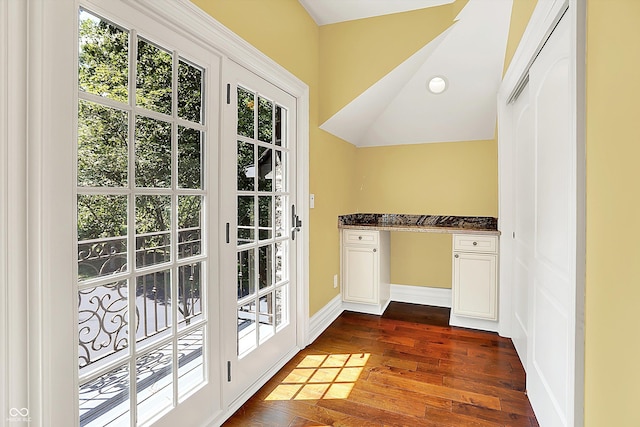 11557 Willow Springs Dr, Zionsville, IN 46077 - doorway with built in desk, vaulted ceiling, and dark wood finished floors