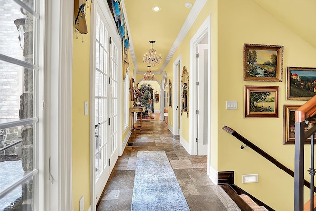 11557 Willow Springs Dr, Zionsville, IN 46077 - hall featuring stone tile flooring, french doors, a chandelier, crown molding, and recessed lighting