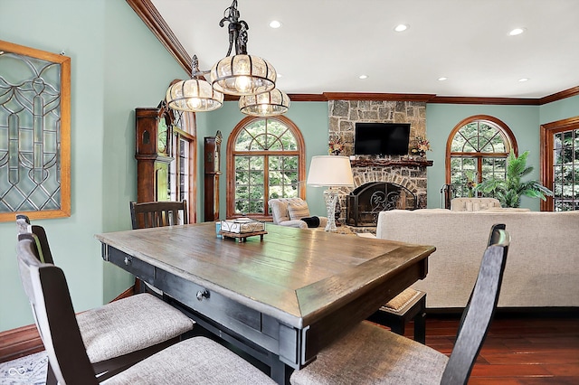 11557 Willow Springs Dr, Zionsville, IN 46077 - dining area with crown molding, wood finished floors, recessed lighting, and a fireplace