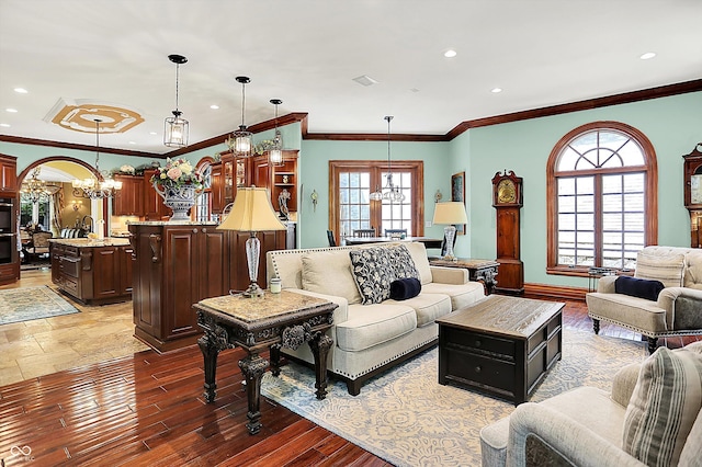 11557 Willow Springs Dr, Zionsville, IN 46077 - living area featuring a chandelier, recessed lighting, wood finished floors, and crown molding