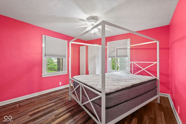 1739 Caldwell Pl, Columbus, IN 47201 - bedroom with wood finished floors, multiple windows, a textured ceiling, and ceiling fan