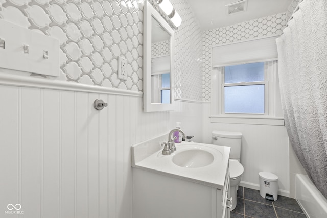 1739 Caldwell Pl, Columbus, IN 47201 - bathroom with vanity, wainscoting, tile patterned floors, wallpapered walls, and shower / tub combo with curtain