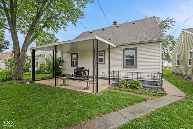 1739 Caldwell Pl, Columbus, IN 47201 - back of house featuring a yard, roof with shingles, and a patio