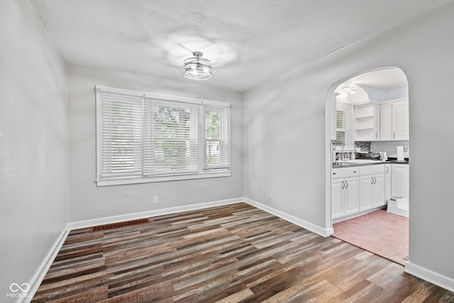 1739 Caldwell Pl, Columbus, IN 47201 - unfurnished dining area with wood finished floors and arched walkways