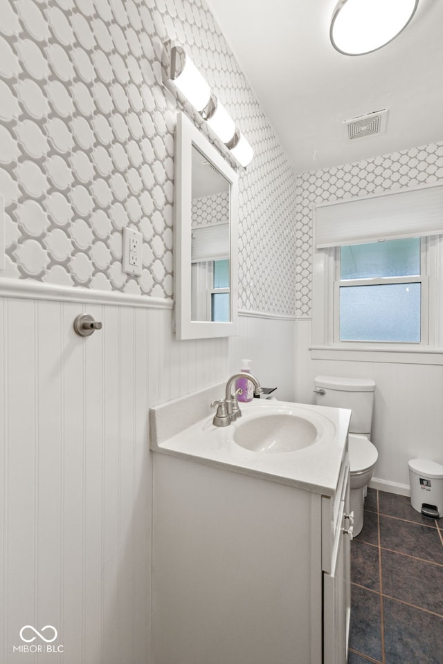 1739 Caldwell Pl, Columbus, IN 47201 - bathroom featuring vanity, wallpapered walls, wainscoting, and tile patterned flooring
