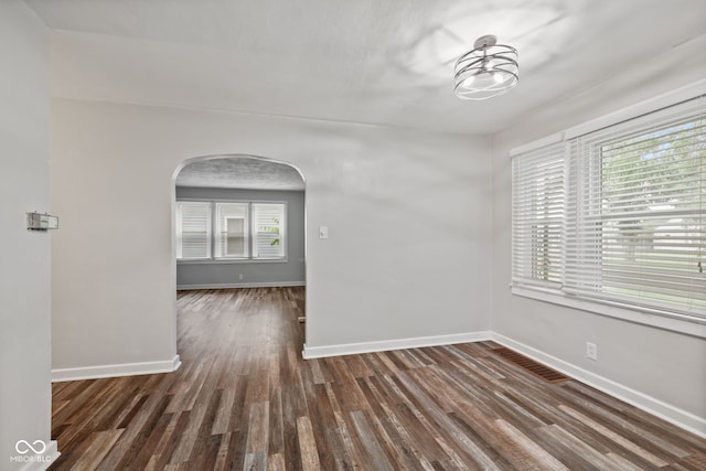 1739 Caldwell Pl, Columbus, IN 47201 - spare room featuring arched walkways and wood finished floors