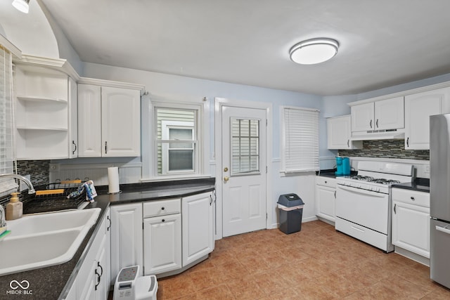 1739 Caldwell Pl, Columbus, IN 47201 - kitchen with white gas range oven, backsplash, white cabinetry, and dark countertops