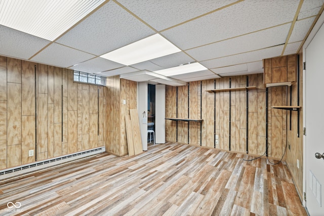 1739 Caldwell Pl, Columbus, IN 47201 - below grade area featuring wood walls, wood finished floors, a baseboard heating unit, and a paneled ceiling
