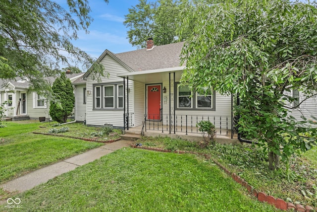 1739 Caldwell Pl, Columbus, IN 47201 - bungalow featuring a shingled roof, a front lawn, a chimney, and a porch