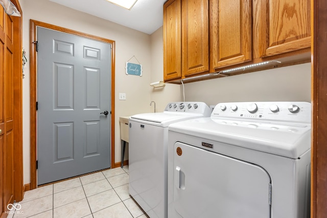 2872 N Prairie Stream Way, Columbus, IN 47203 - laundry area featuring separate washer and dryer, cabinet space, and light tile patterned flooring