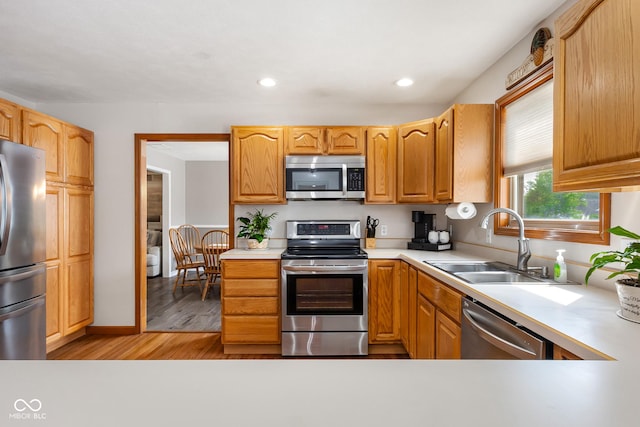 2872 N Prairie Stream Way, Columbus, IN 47203 - kitchen featuring stainless steel appliances, light wood finished floors, light countertops, and recessed lighting