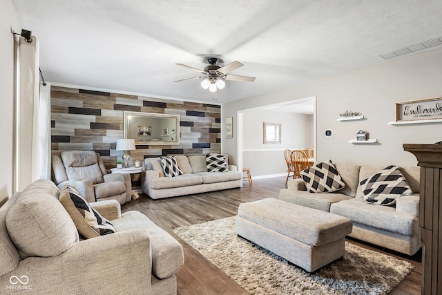 2872 N Prairie Stream Way, Columbus, IN 47203 - living room with an accent wall, ceiling fan, and wood finished floors
