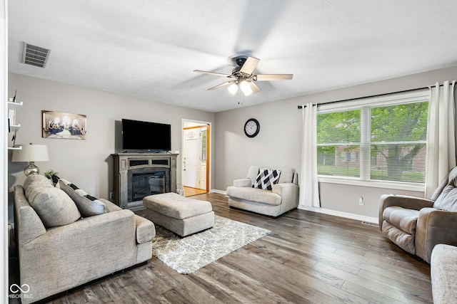 2872 N Prairie Stream Way, Columbus, IN 47203 - living area with wood finished floors, a ceiling fan, and a glass covered fireplace