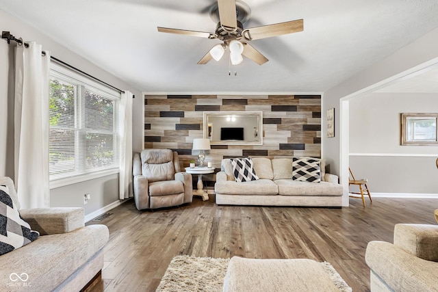 2872 N Prairie Stream Way, Columbus, IN 47203 - living room with an accent wall, ceiling fan, plenty of natural light, and wood finished floors