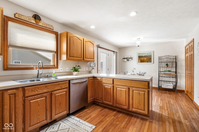 2872 N Prairie Stream Way, Columbus, IN 47203 - kitchen with dishwasher, a peninsula, light wood-type flooring, light countertops, and recessed lighting