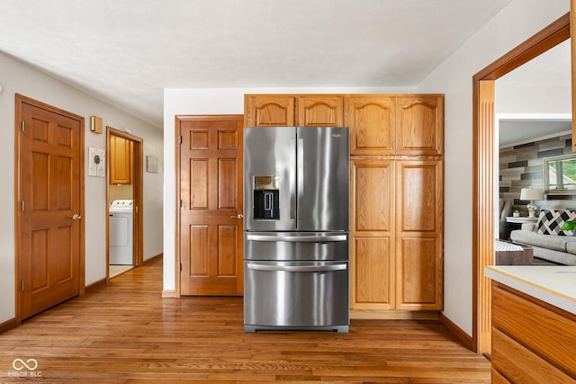 2872 N Prairie Stream Way, Columbus, IN 47203 - kitchen featuring stainless steel fridge, washer / clothes dryer, light wood finished floors, and light countertops
