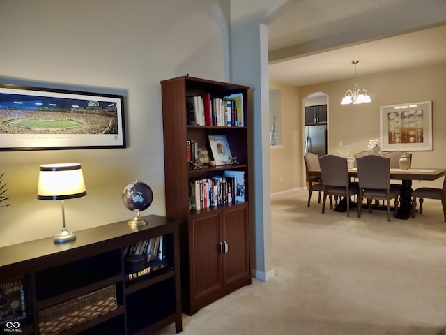 5932 Edelle Dr, Indianapolis, IN 46237 - dining space featuring arched walkways, light colored carpet, and a chandelier