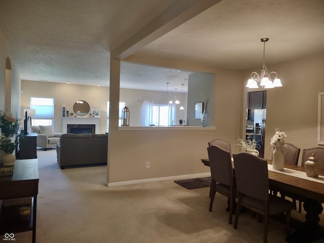 5932 Edelle Dr, Indianapolis, IN 46237 - dining space featuring a fireplace, light carpet, healthy amount of natural light, and a chandelier