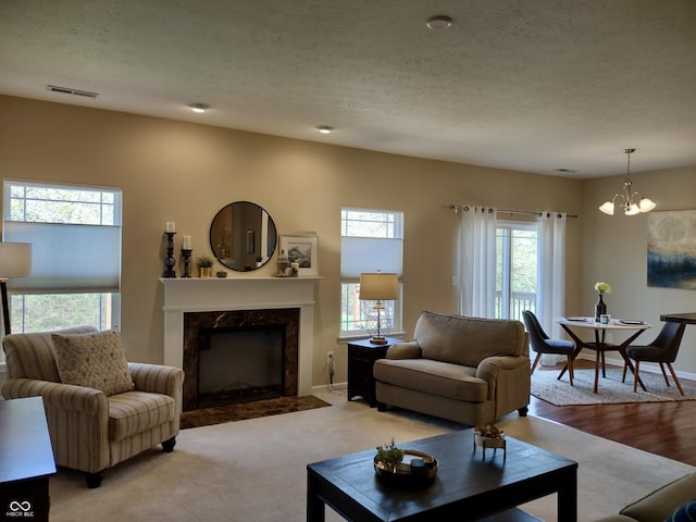 5932 Edelle Dr, Indianapolis, IN 46237 - living area with a chandelier, a high end fireplace, and a textured ceiling