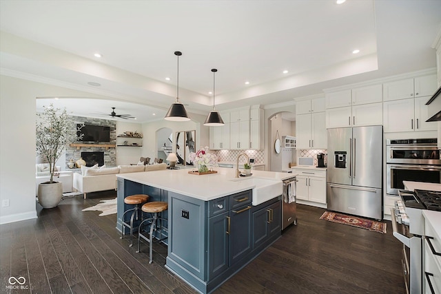 5706 Bentbrook Dr, Bargersville, IN 46106 - kitchen with stainless steel appliances, white cabinets, open floor plan, ceiling fan, and dark wood-style flooring