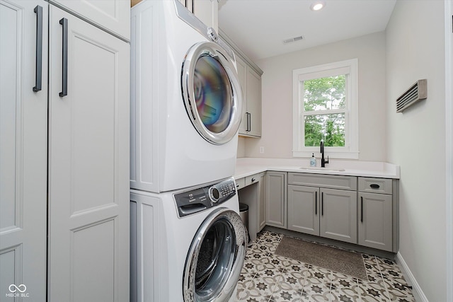 5706 Bentbrook Dr, Bargersville, IN 46106 - washroom featuring stacked washer / drying machine, cabinet space, recessed lighting, and light tile patterned floors