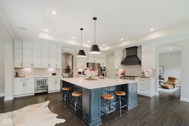 5706 Bentbrook Dr, Bargersville, IN 46106 - kitchen with wall chimney range hood, beverage cooler, arched walkways, decorative backsplash, and recessed lighting