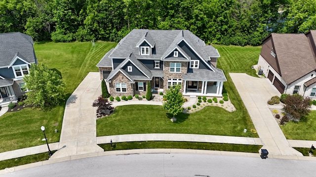 5706 Bentbrook Dr, Bargersville, IN 46106 - view of front facade featuring stone siding, covered porch, concrete driveway, a garage, and a front yard