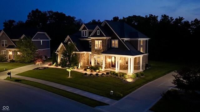 5706 Bentbrook Dr, Bargersville, IN 46106 - view of front facade with stone siding, a lawn, concrete driveway, and a porch