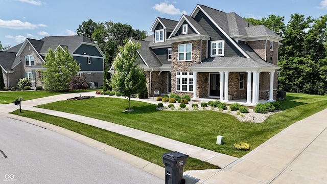 5706 Bentbrook Dr, Bargersville, IN 46106 - view of front facade featuring stone siding, covered porch, and a front lawn